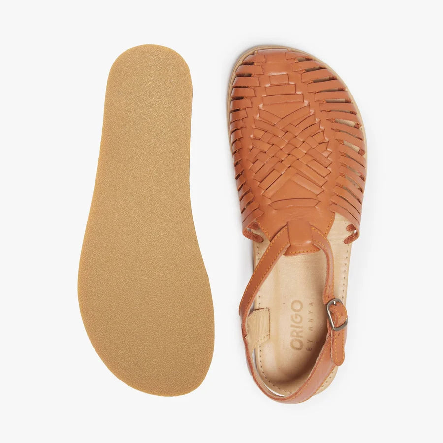 Tan huarache sandal with insole and outsole visible; woven upper with ankle strap.