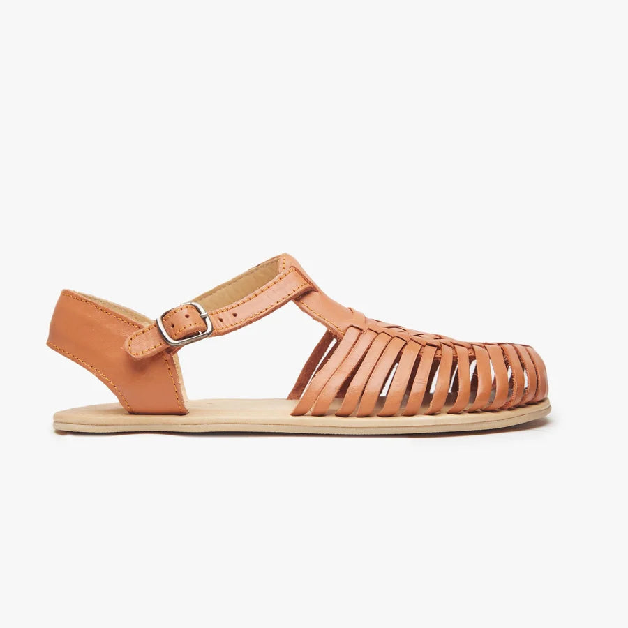Tan Origo huarache sandal with adjustable buckle ankle strap and braided straps.