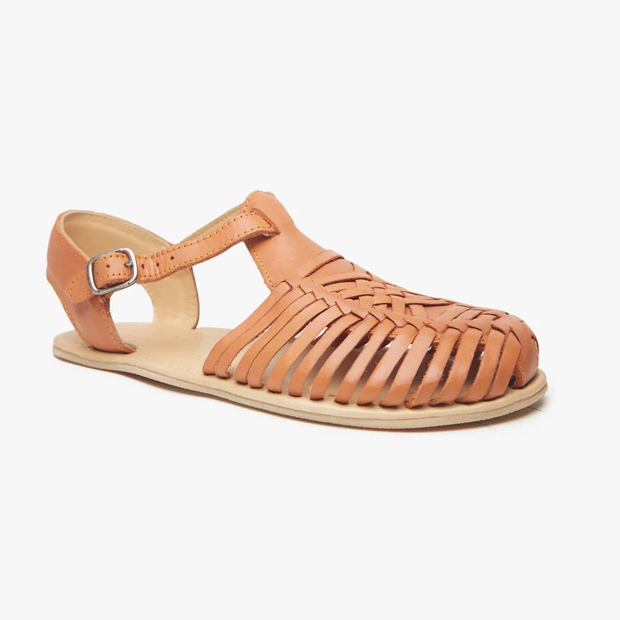 Tan Origo huarache sandal with open toe, ankle strap, and flat sole.