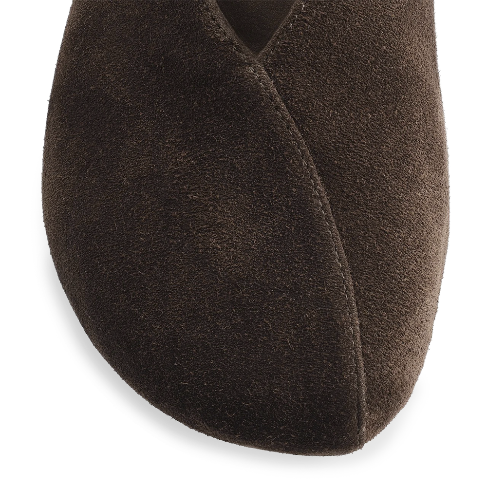 Close-up of the dark brown flat's rounded toe and curved seam