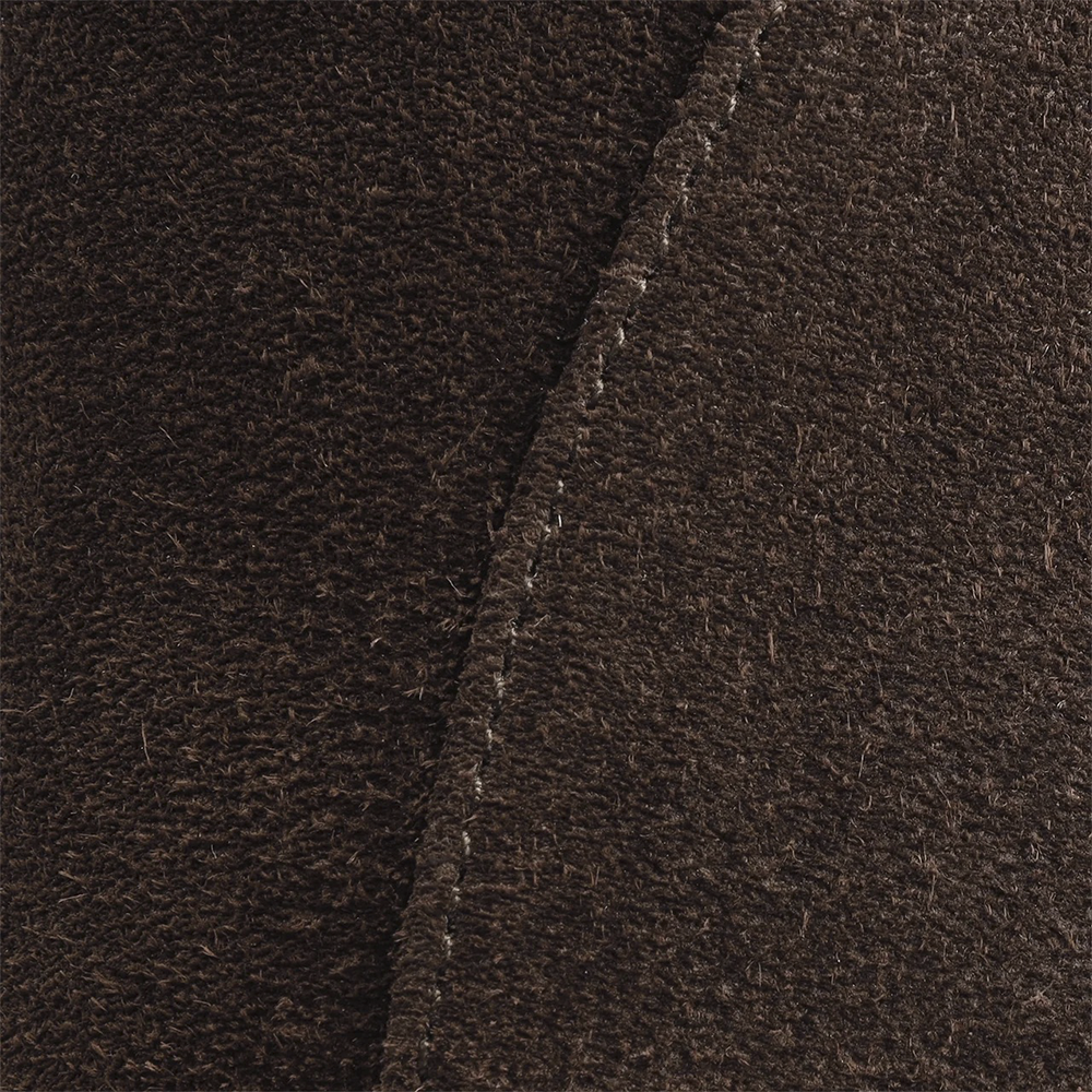 Close-up of the flat's brown suede texture and stitching