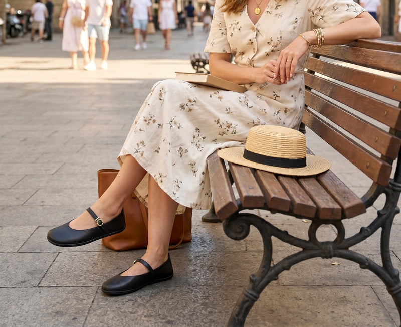 Black ballet flats with round toe and gold buckle strap, low-profile slip-on design