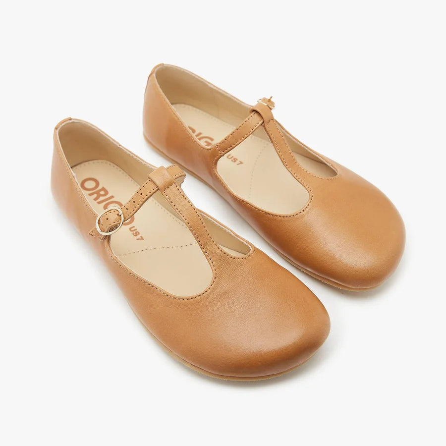 Pair of Origo women's tan T-strap flats with buckle straps and rounded toe