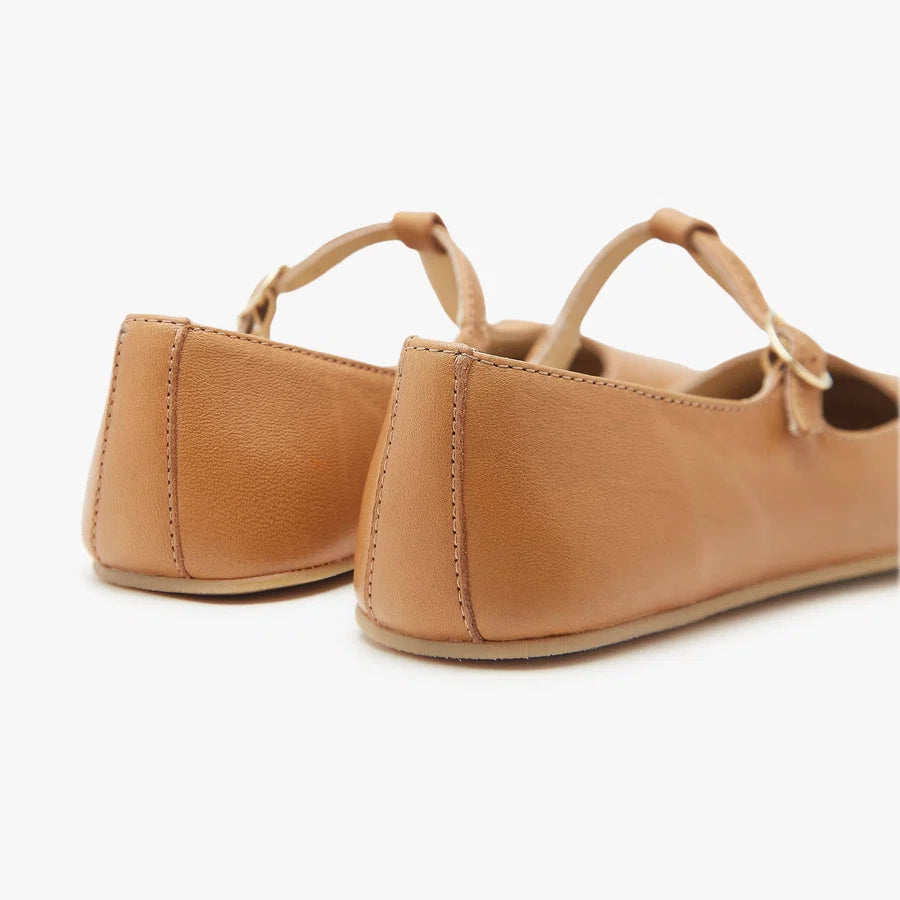 Origo women's tan T-strap flats from heel view with strap and pull tab