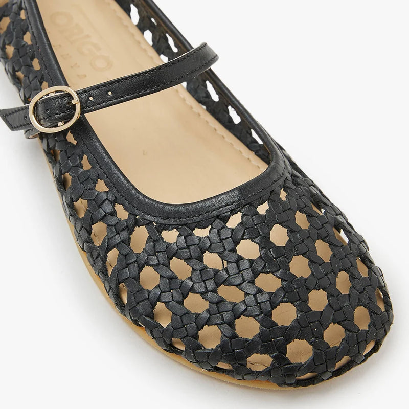 Close-up of women's woven ballerina toe and strap, dark black, gold-tone buckle